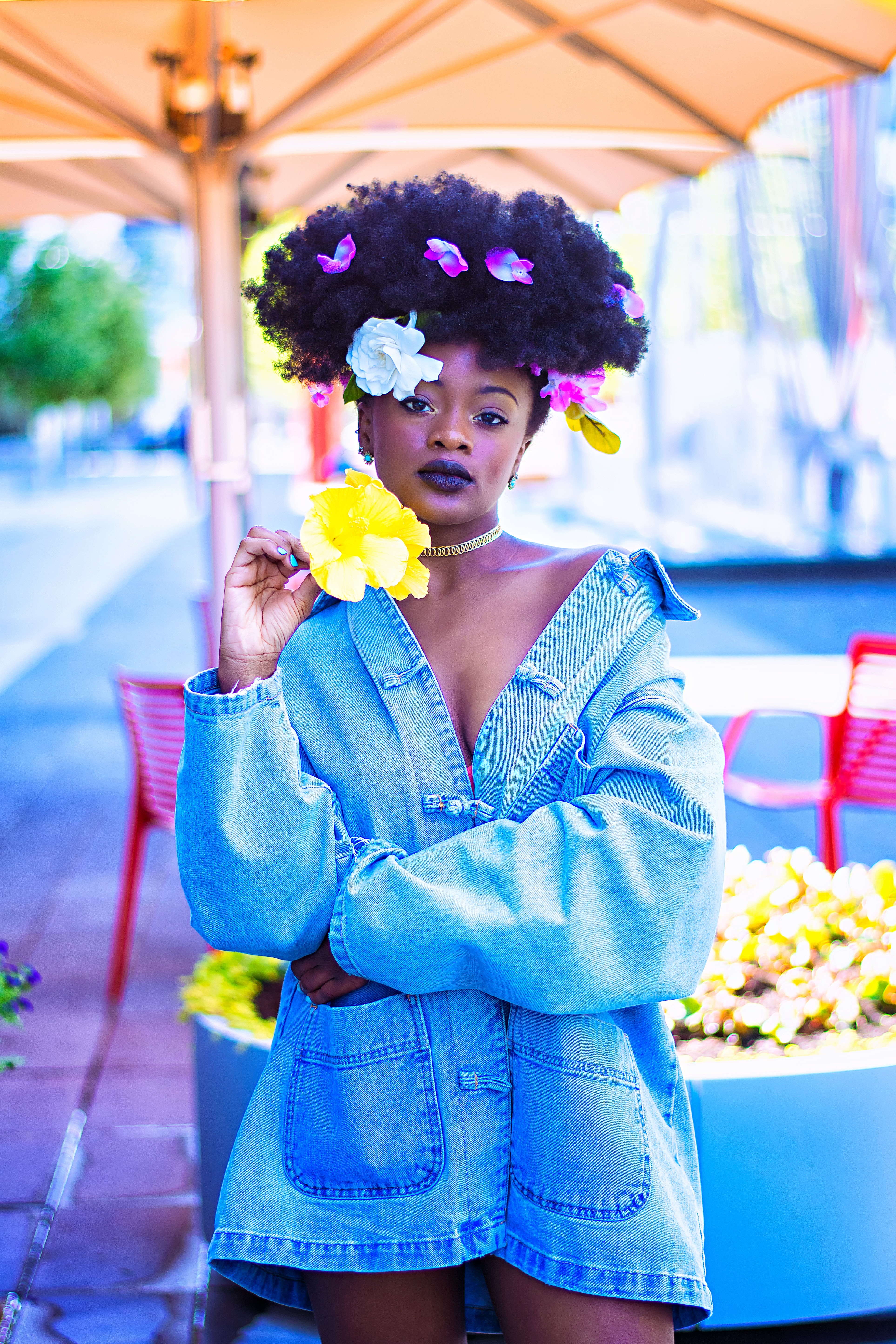 Image of woman standing with a short jean dress on.